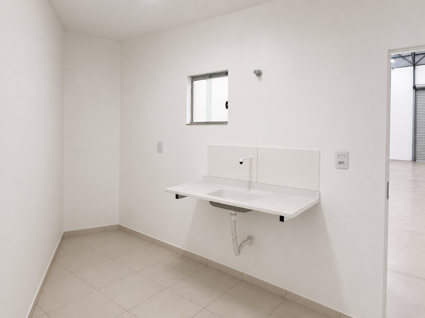Cozinha do depósito industrial em Monte Verde, Betim, com bancada de pia e porcelanato claro