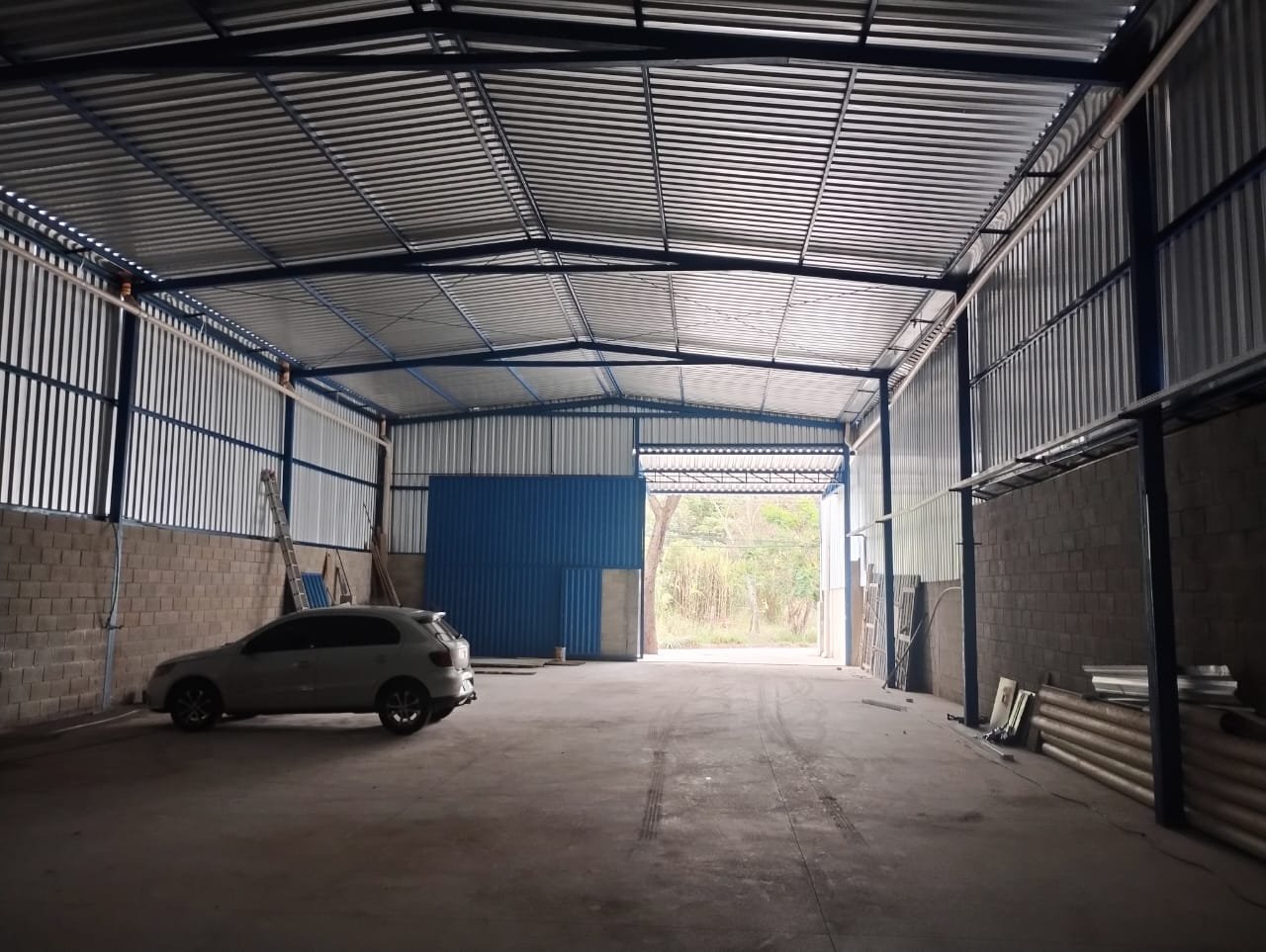 Vão livre do galpão com portão de acesso ao fundo Vão livre do galpão de 420 m² com piso usinado industrial e portão de acesso ao fundo, em Betim/MG